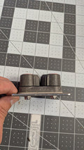 Harken double cam cleat side view on 1-inch grid