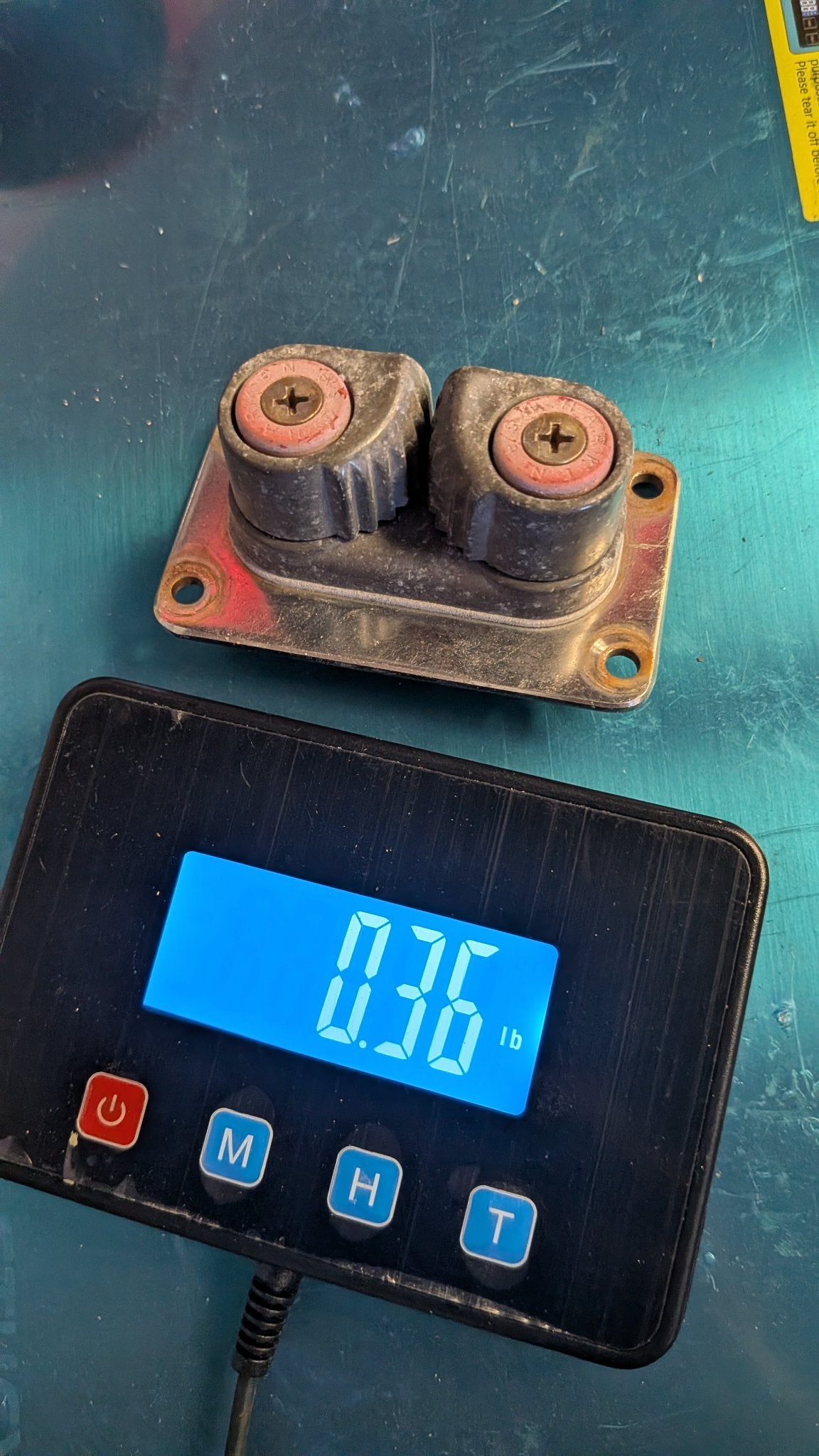 Harken double cam cleat on scale showing 0.36 lb