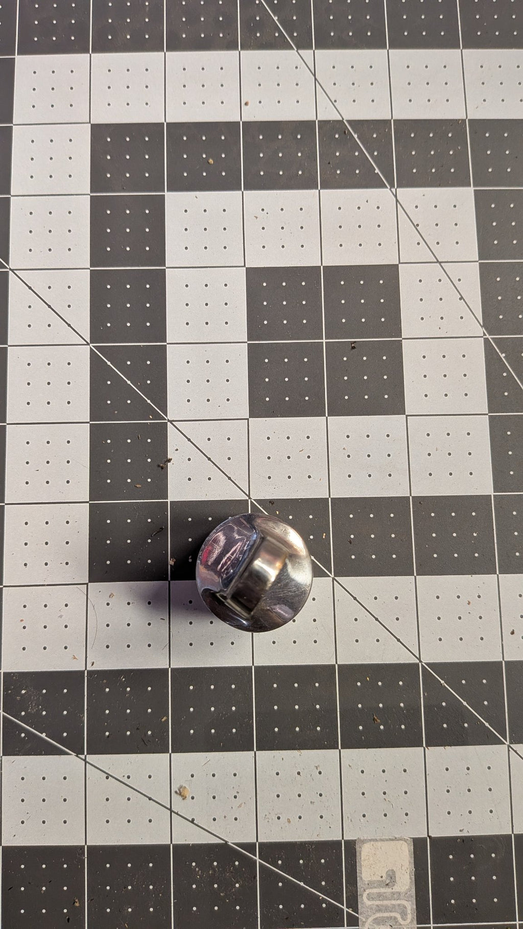 Top-down view of stanchion top cap on 1-inch grid