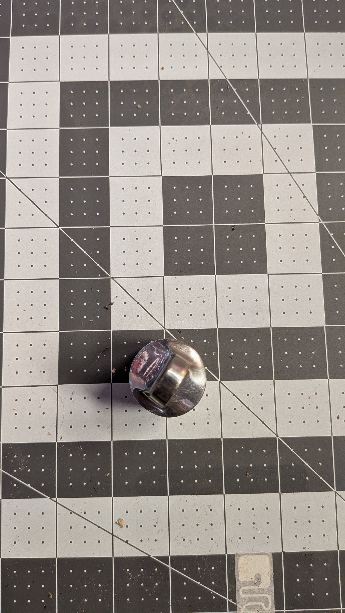 Top-down view of stanchion top cap on 1-inch grid