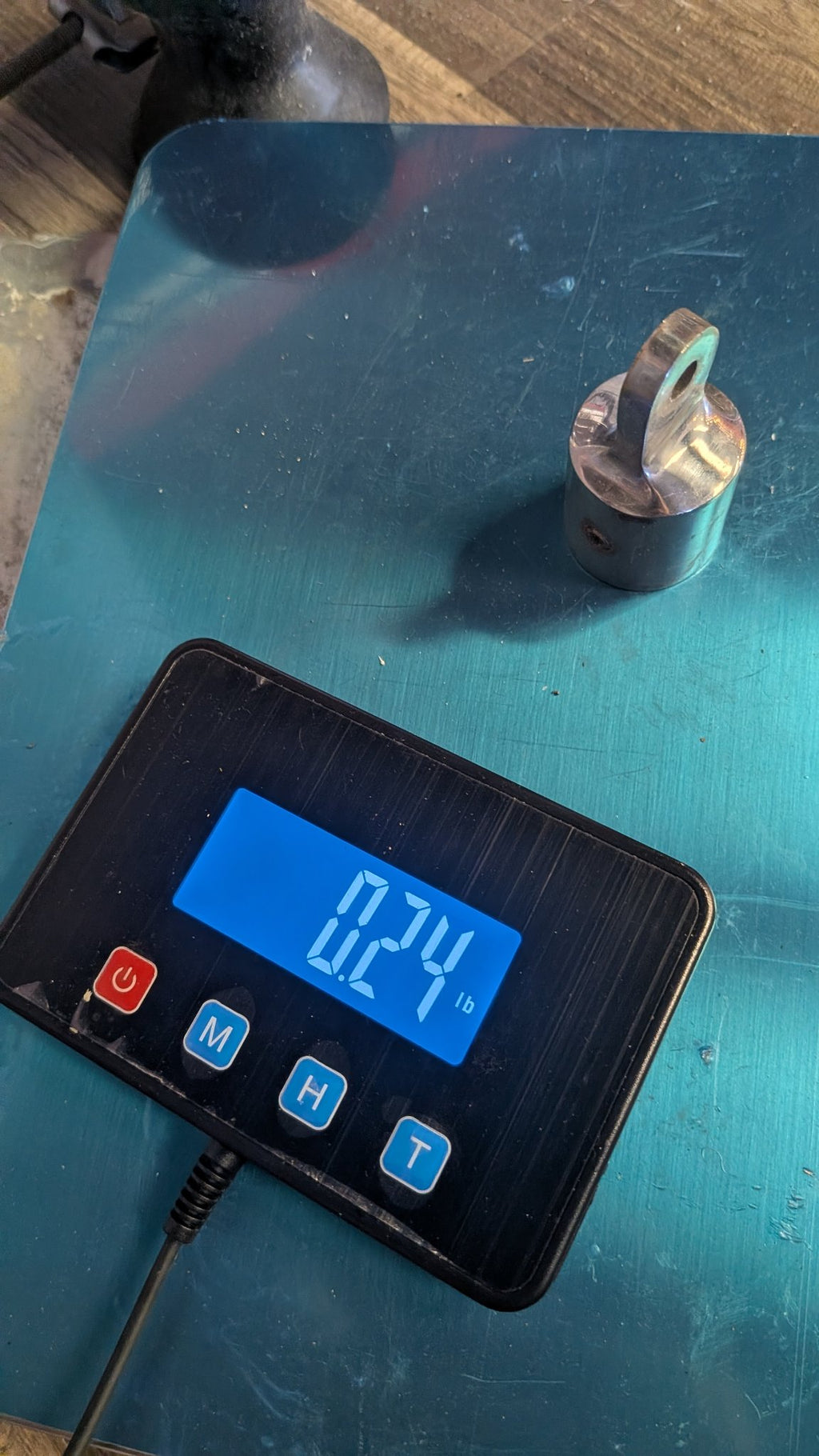 Stanchion top cap on scale showing 0.24 lb