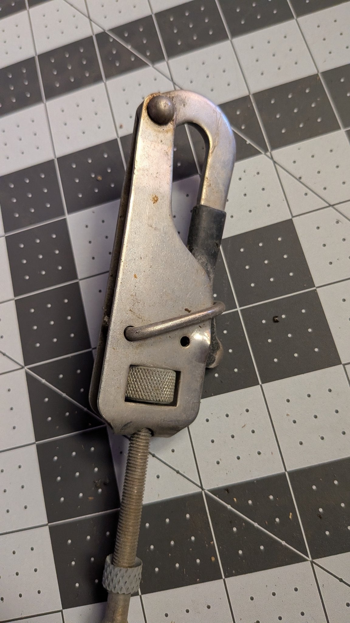 Gate hook body with knurled tensioning wheel close-up
