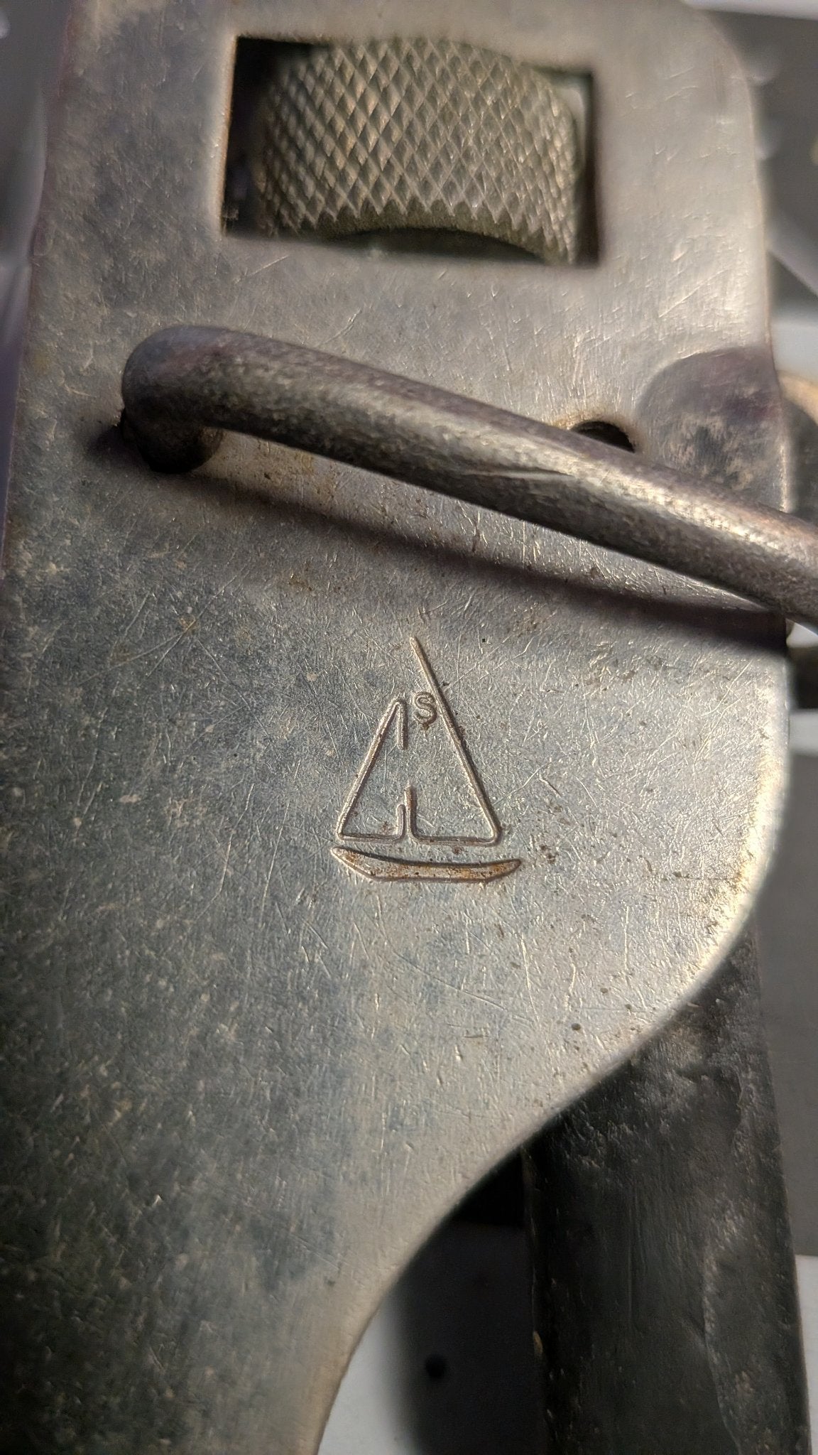 Stamped maker's mark sailboat logo on gate hook