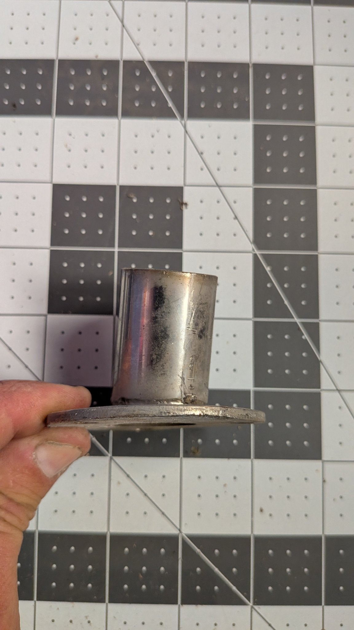 Stainless angled stanchion base side view on 1-inch grid
