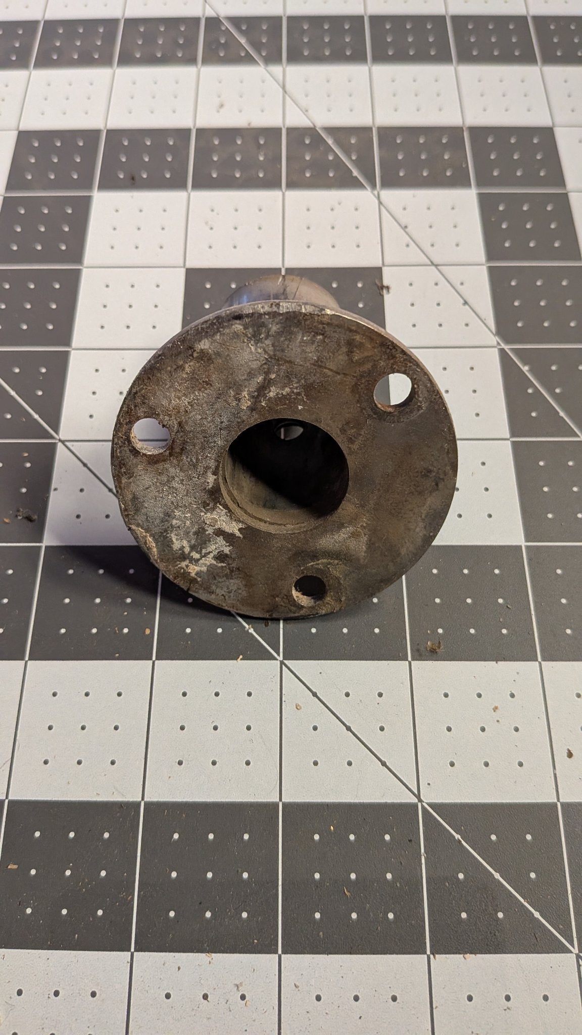 Underside of angled stanchion base flange on 1-inch grid