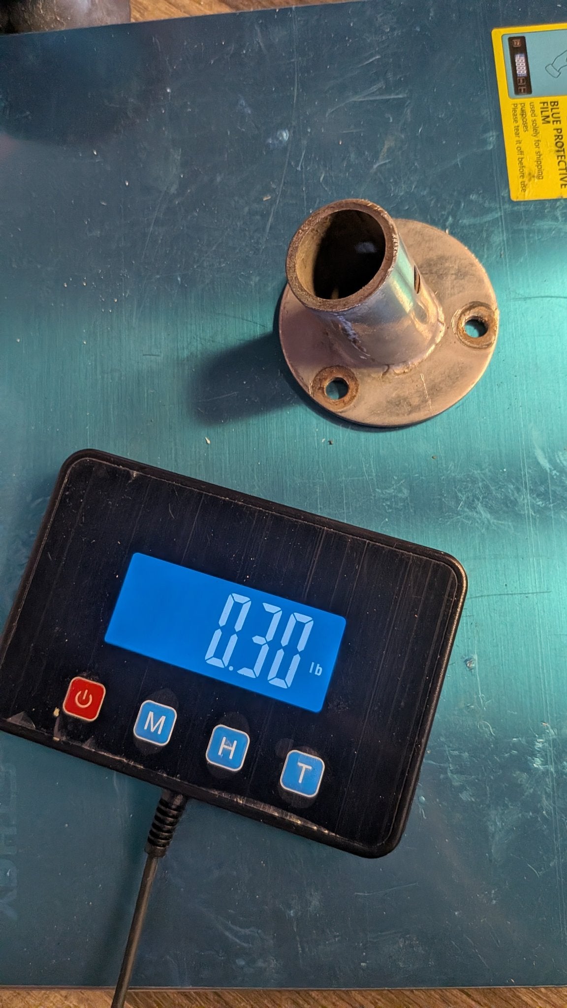 Angled stanchion base on scale showing 0.30 lb