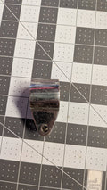 Stainless hinged jaw slide with forked tang side view on 1-inch grid