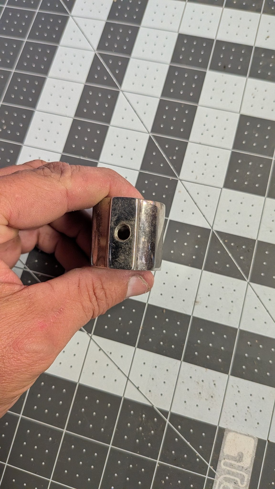 Jaw slide hinge pin hole close-up held in hand