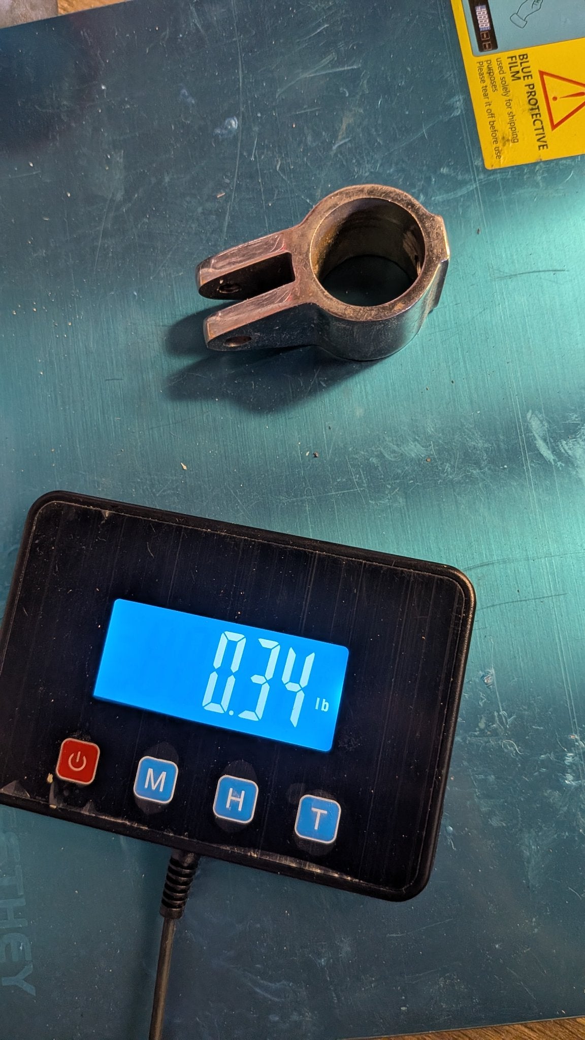 Stainless jaw slide on scale showing 0.34 lb