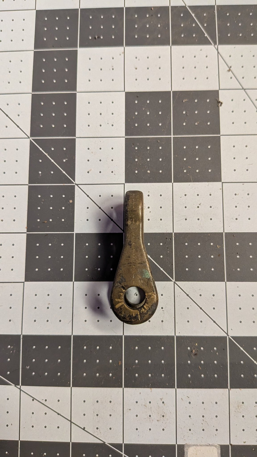 Angled view of bronze toggle on 1-inch grid