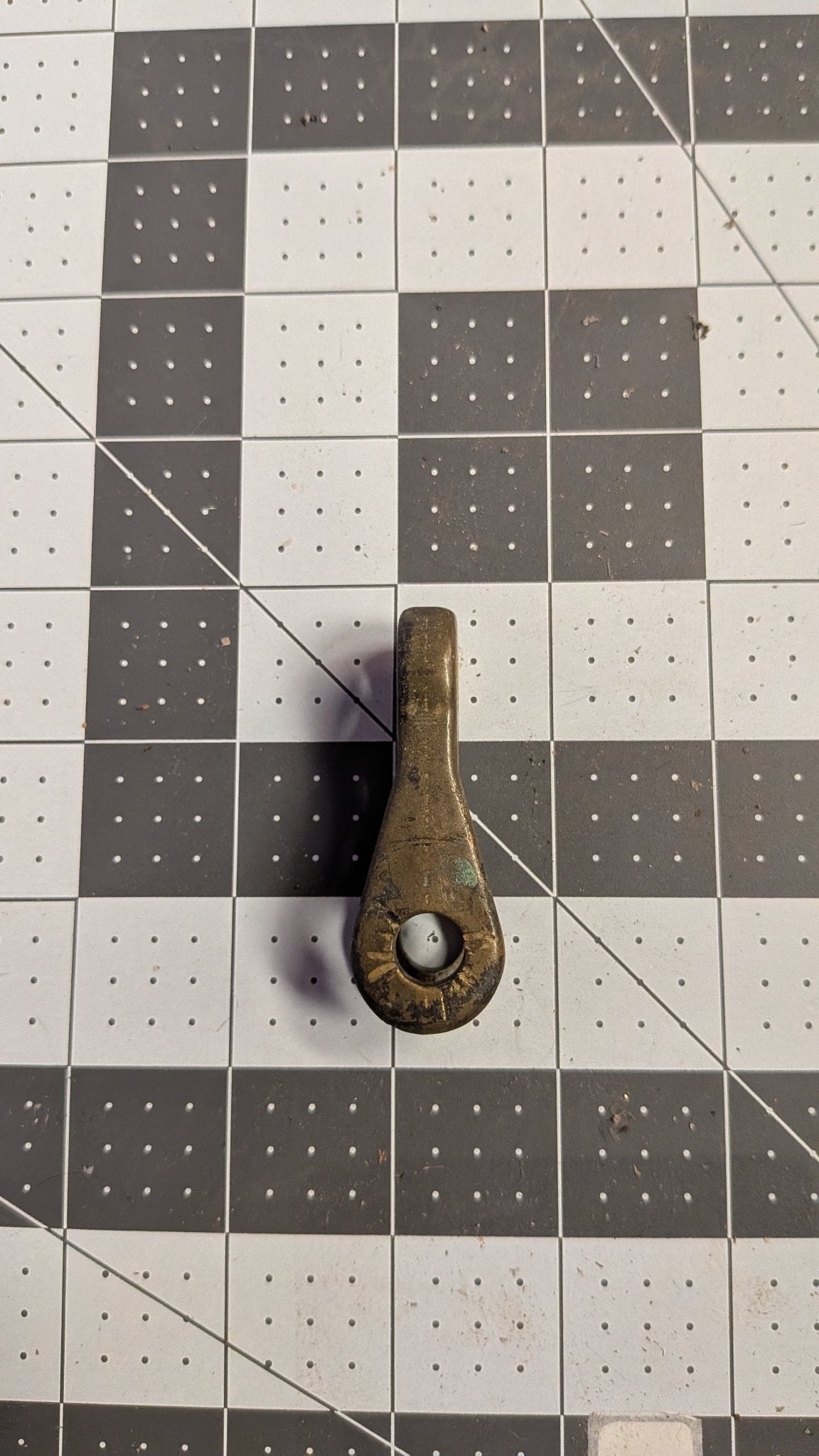 Angled view of bronze toggle on 1-inch grid