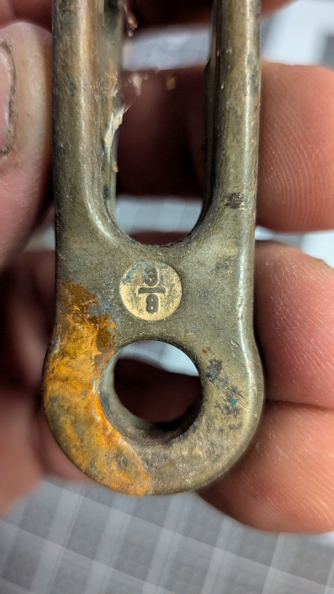 Close-up of 3/8 size stamp on bronze toggle