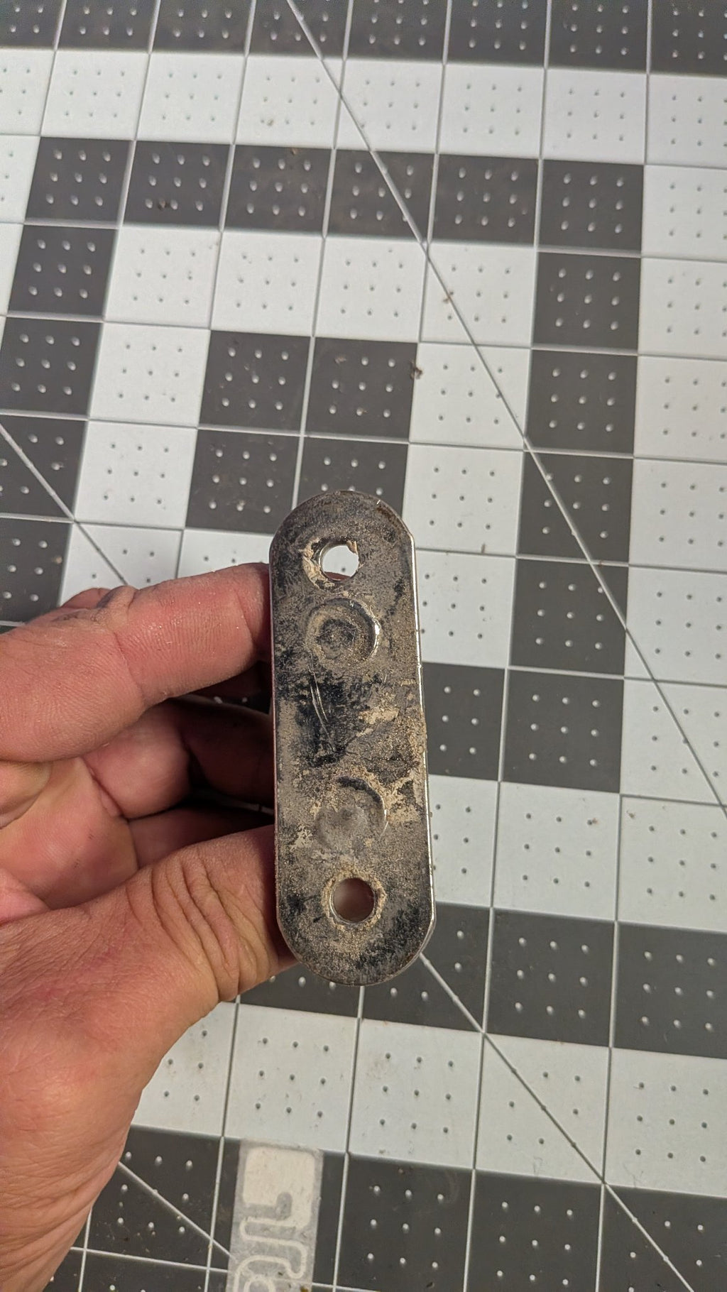 Underside of pad eye base plate held in hand