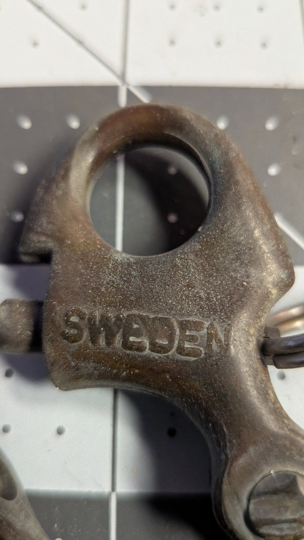 Close-up of SWEDEN stamp on bronze snap shackle