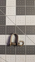 Stainless D-shackle with captive pin and split ring front view on 1-inch grid