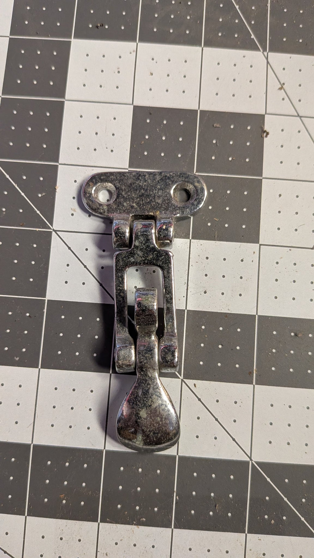 Chromed folding T-handle hatch latch front view on 1-inch grid