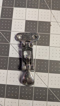 Chromed folding T-handle hatch latch front view on 1-inch grid