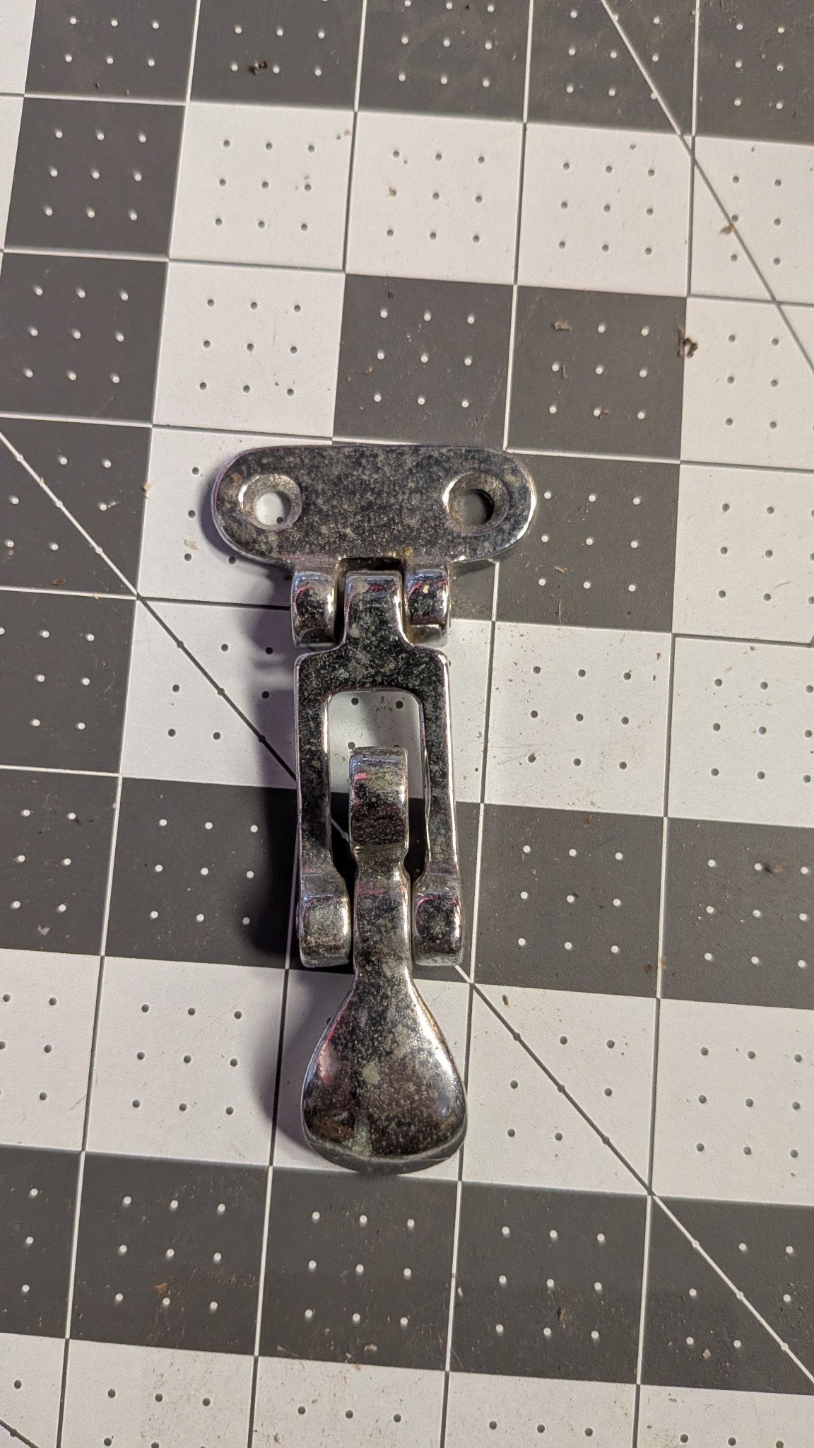 Chromed folding T-handle hatch latch front view on 1-inch grid