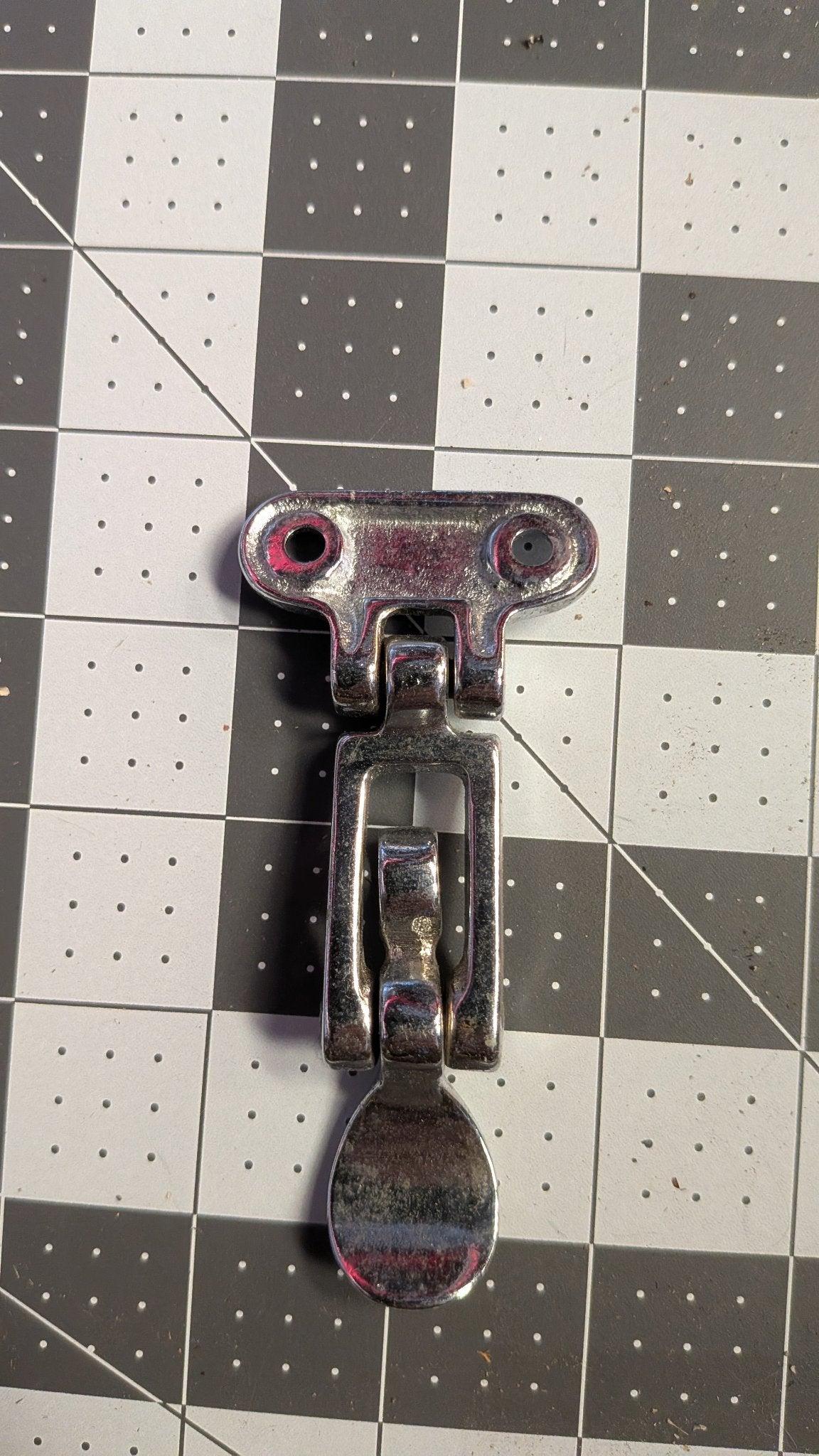 Back view of hatch latch mounting bracket on 1-inch grid