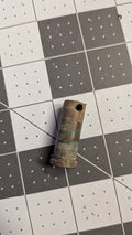 Bronze pivot pin side view with cross-drilled hole on 1-inch grid