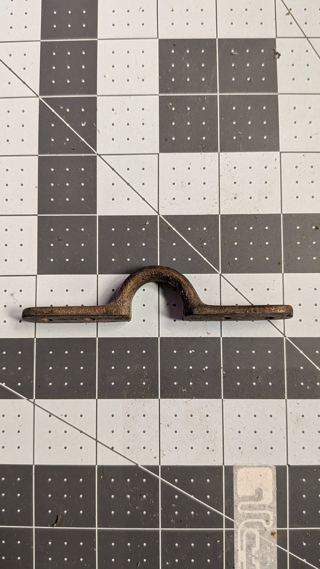 Side view of Perko bronze pad eye on 1-inch grid