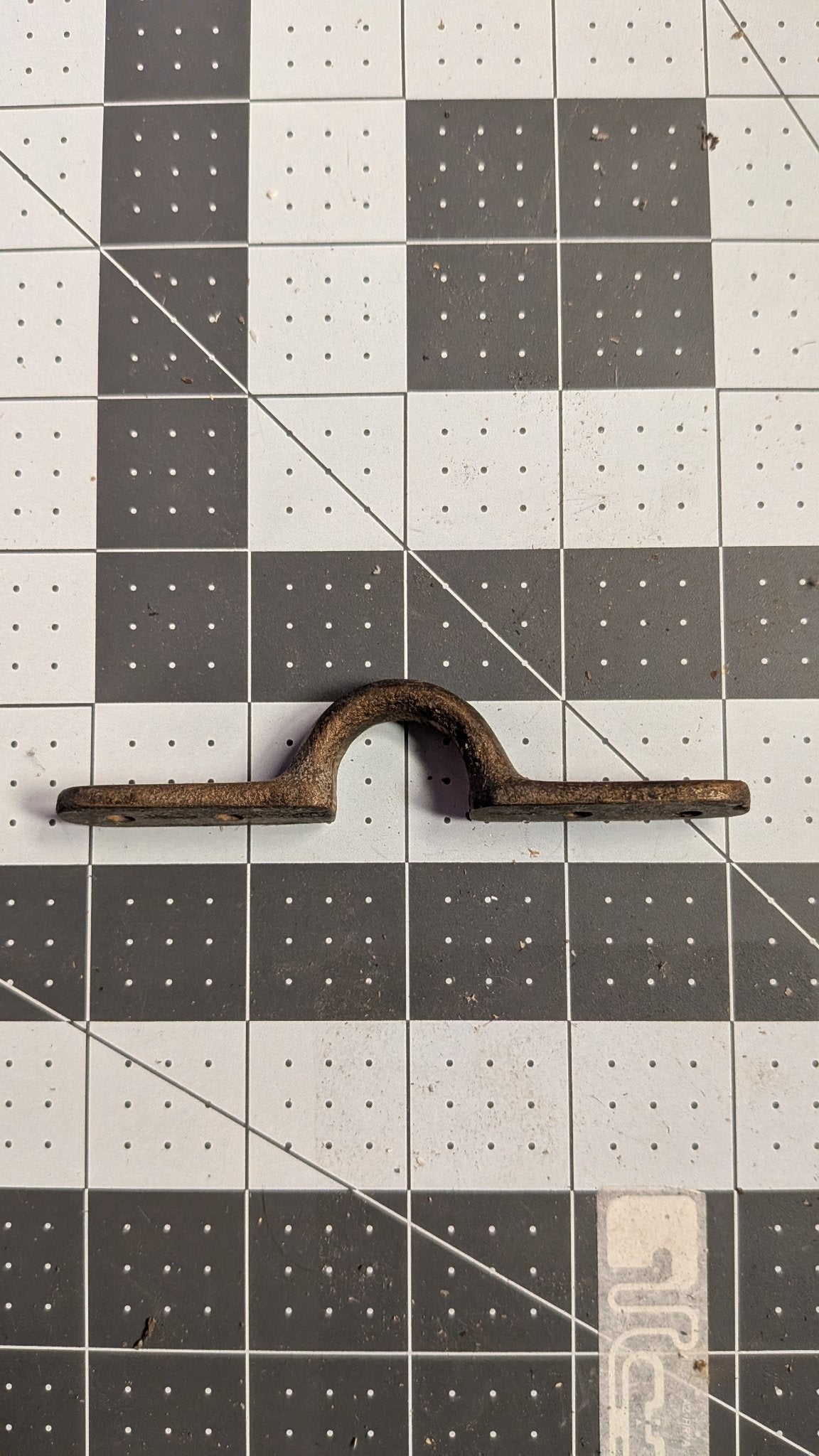Side view of Perko bronze pad eye on 1-inch grid