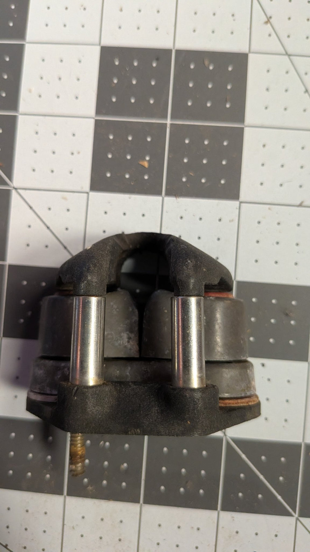 Back view of Harken cam cleat showing mounting stud on 1-inch grid