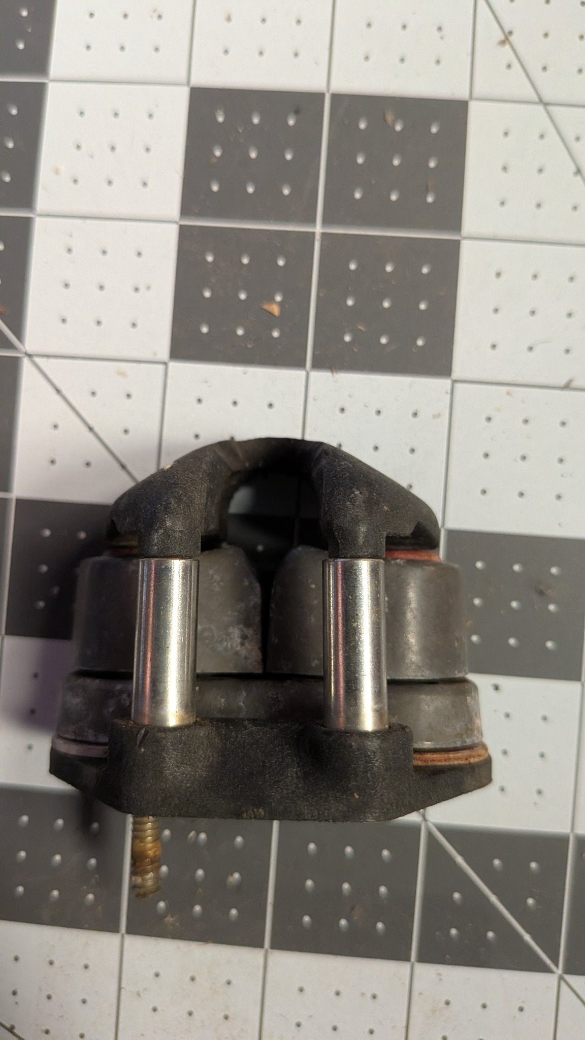 Back view of Harken cam cleat showing mounting stud on 1-inch grid