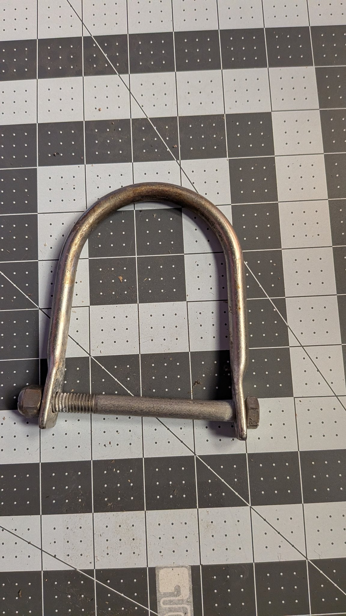 Stainless U-bolt bow eye with nuts front view on 1-inch grid