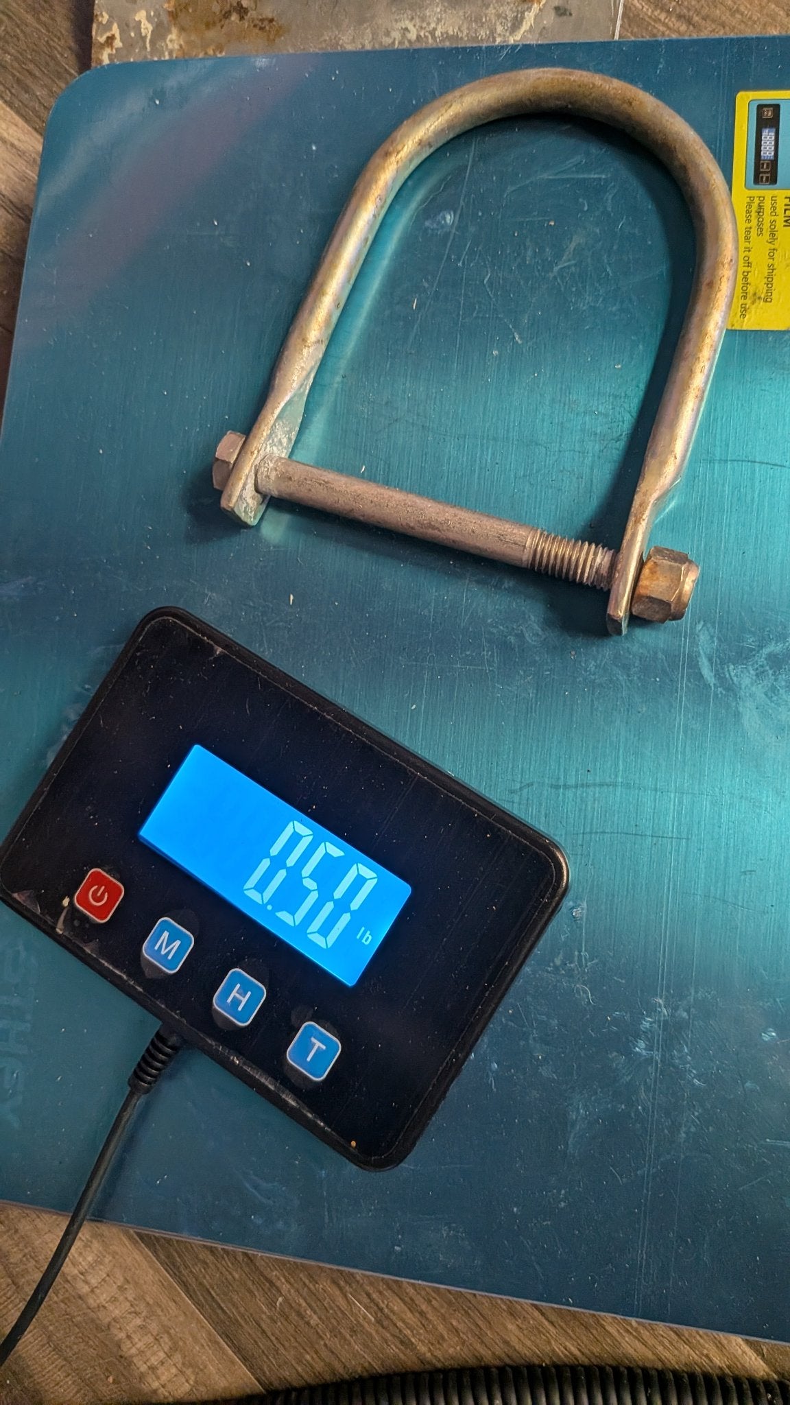 U-bolt on scale showing 0.50 lb