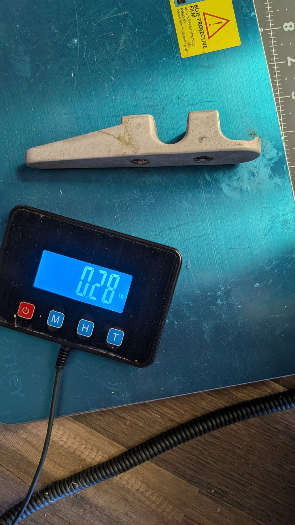 Aluminum fairlead on scale showing 0.28 lb