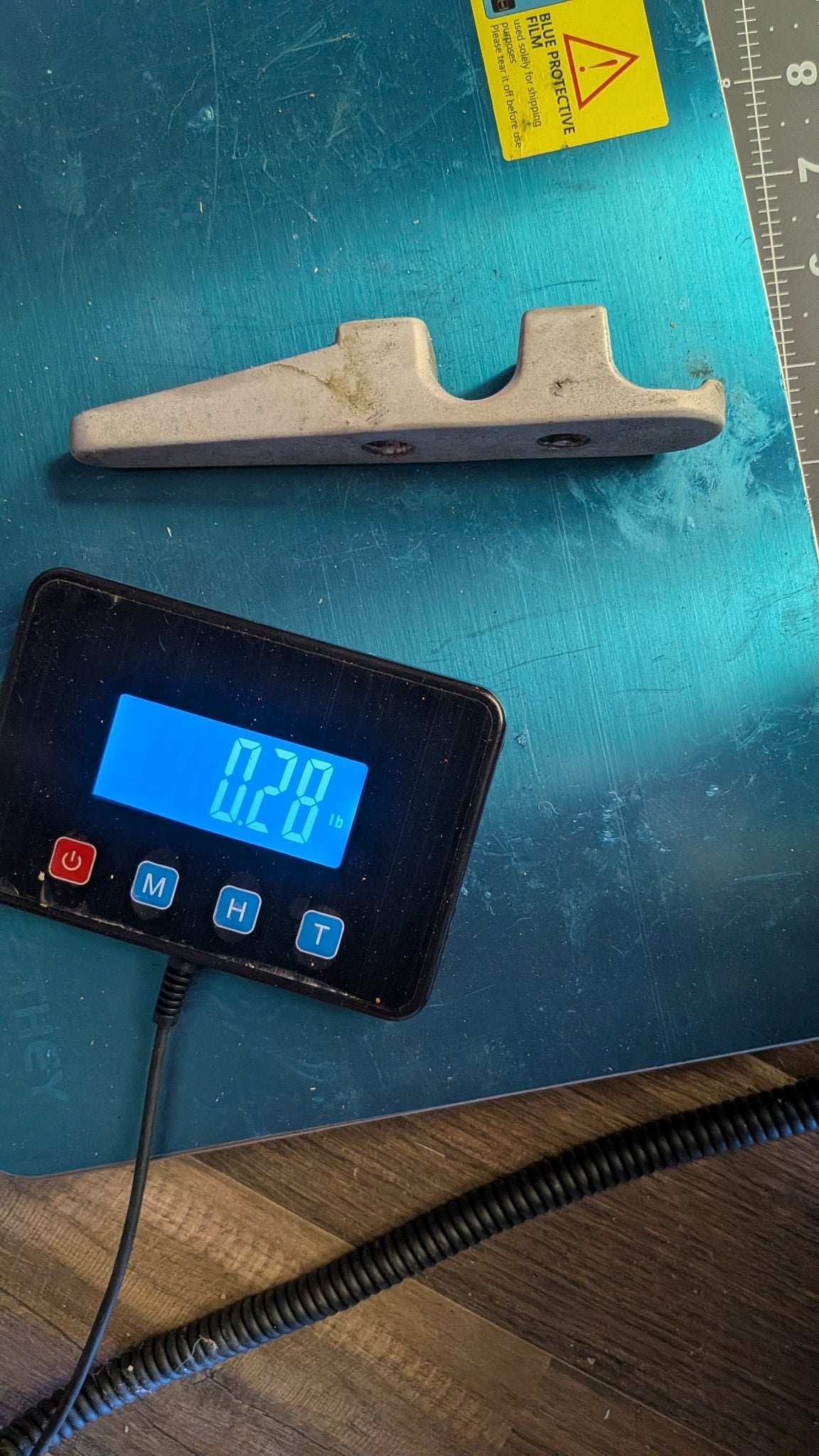 Aluminum fairlead on scale showing 0.28 lb