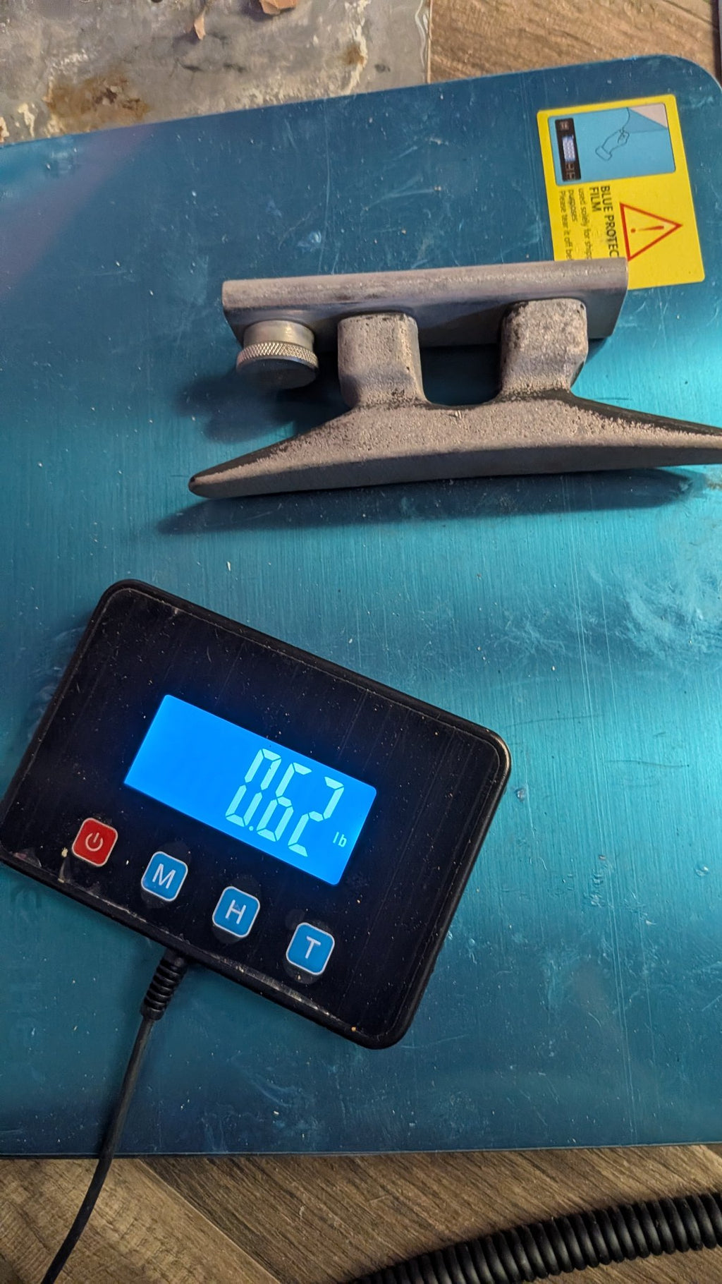 T-track cleat on scale showing 0.62 lb
