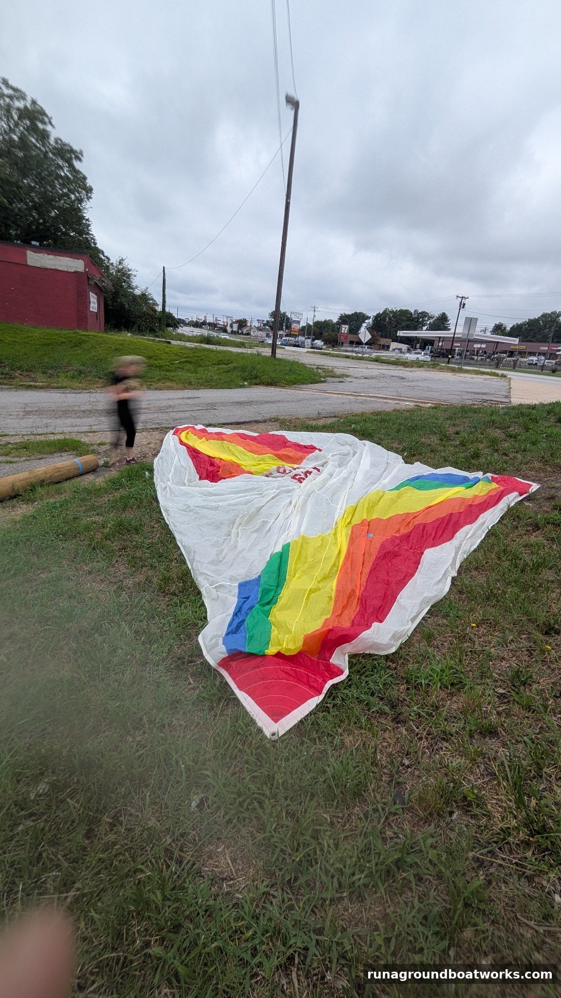 Hood Sails symmetric spinnaker laid out — rainbow panels on white, 26 ft 7 in luff