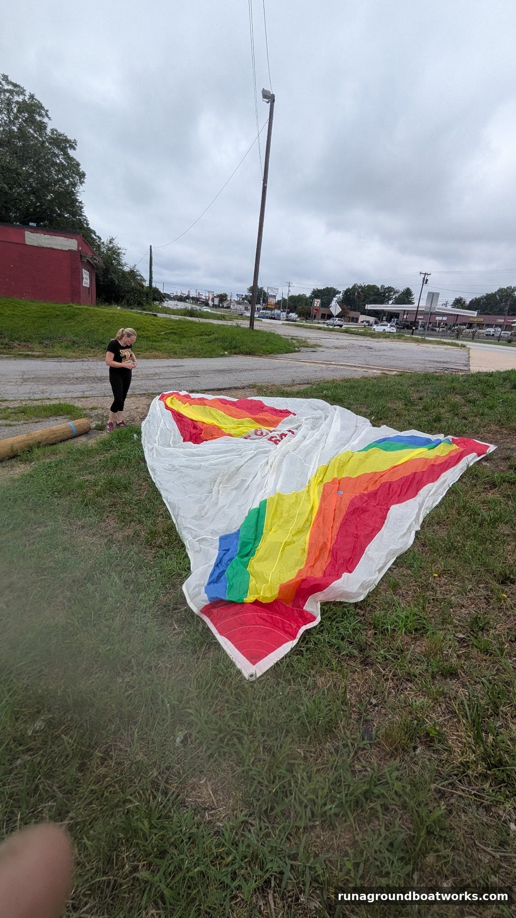 Hood Sails symmetric spinnaker laid out, second view — rainbow panels on white