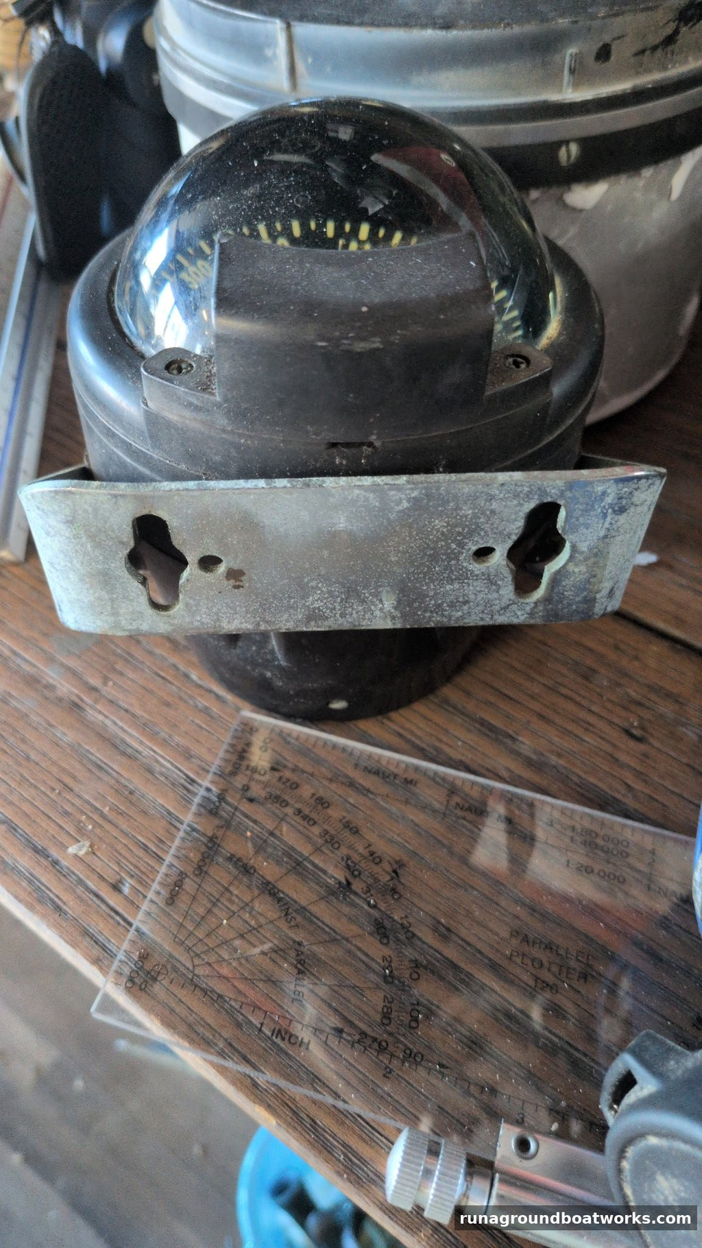 Danforth Corsair compass seated in its metal mounting bracket with keyhole slots