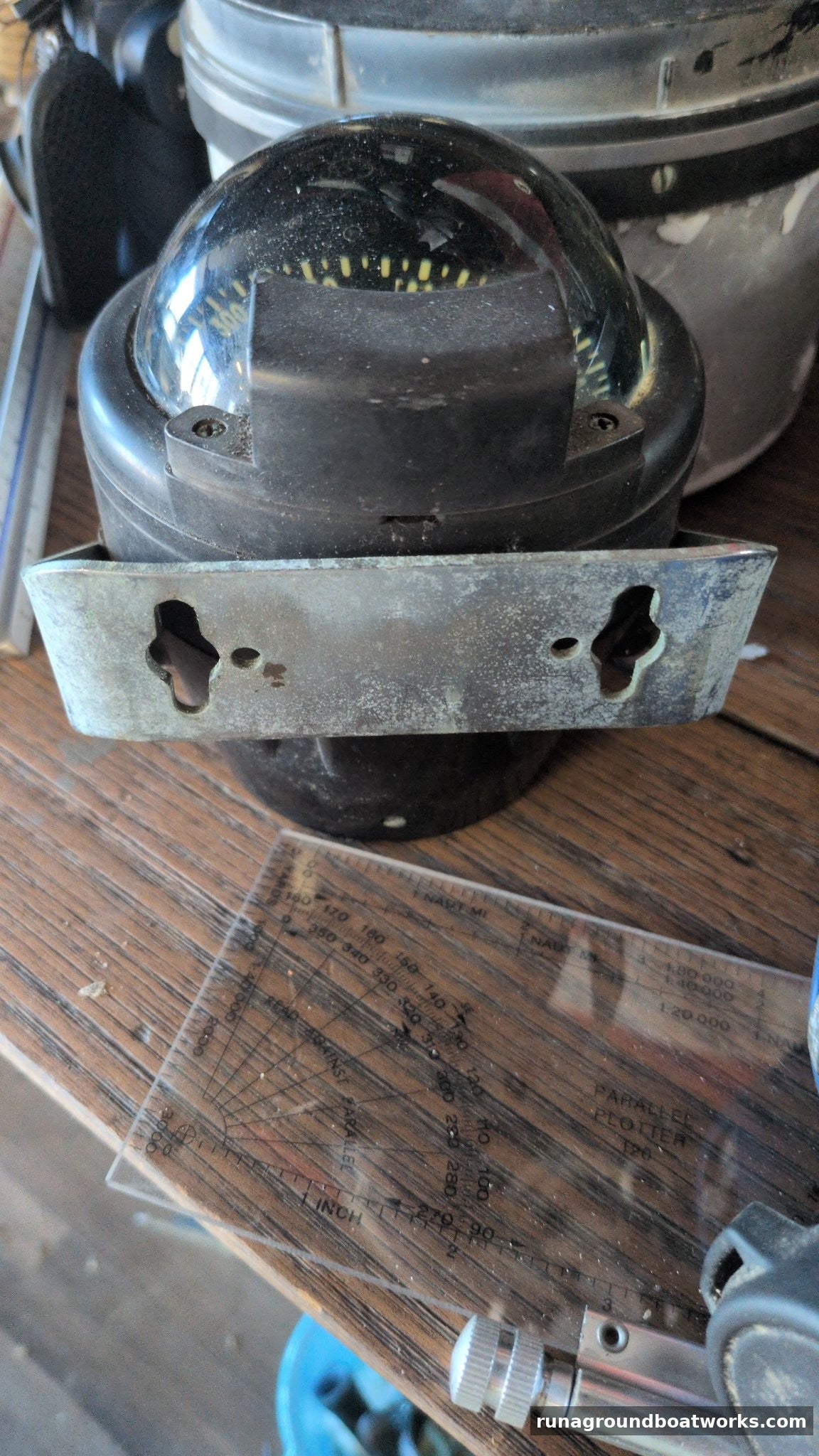 Danforth Corsair compass seated in its metal mounting bracket with keyhole slots