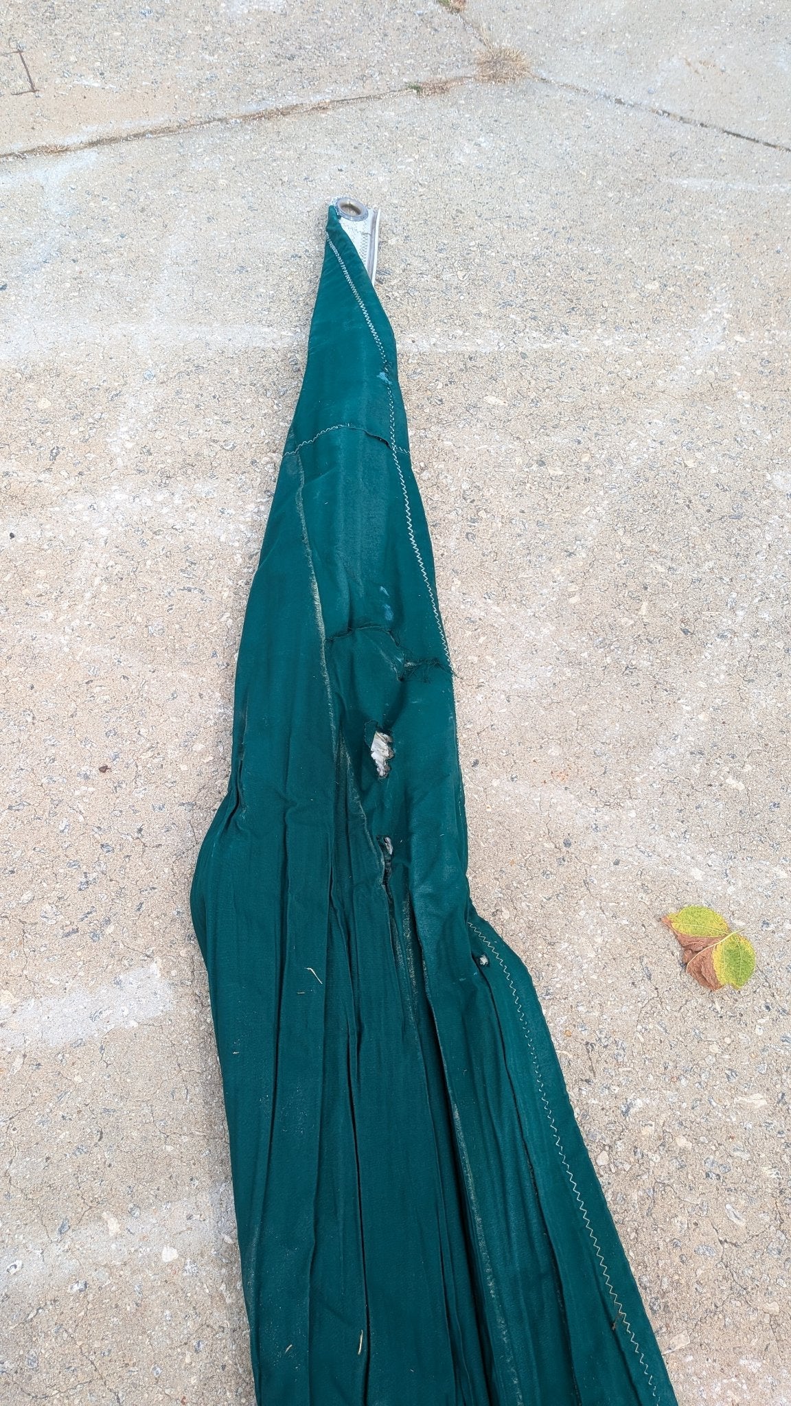 Sail with green sunbrella cover, folded