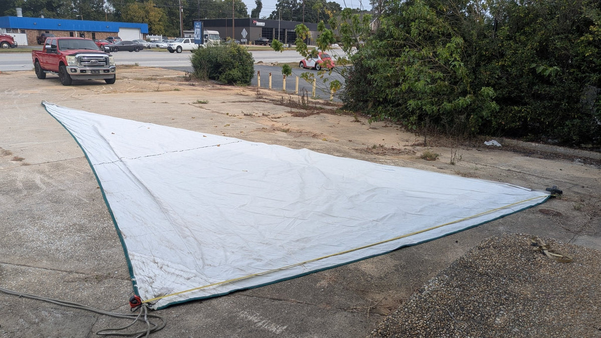 Used furling genoa laid out — white Dacron with green trim