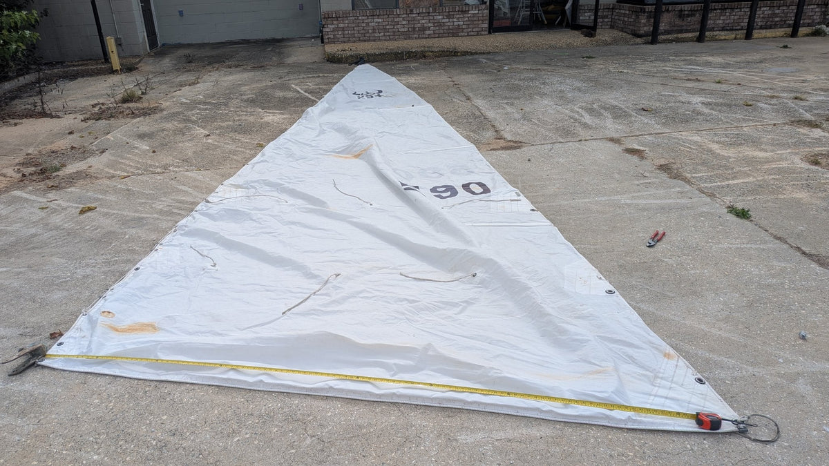 Used mainsail laid out full with tape measure on the foot