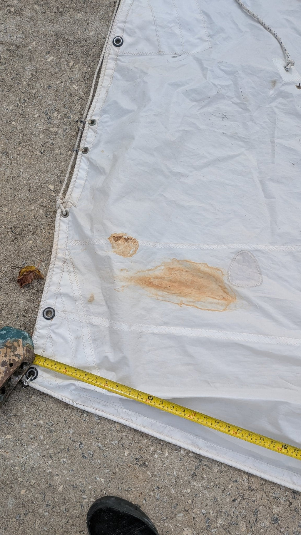 Tack area with tape measure — some rust staining visible