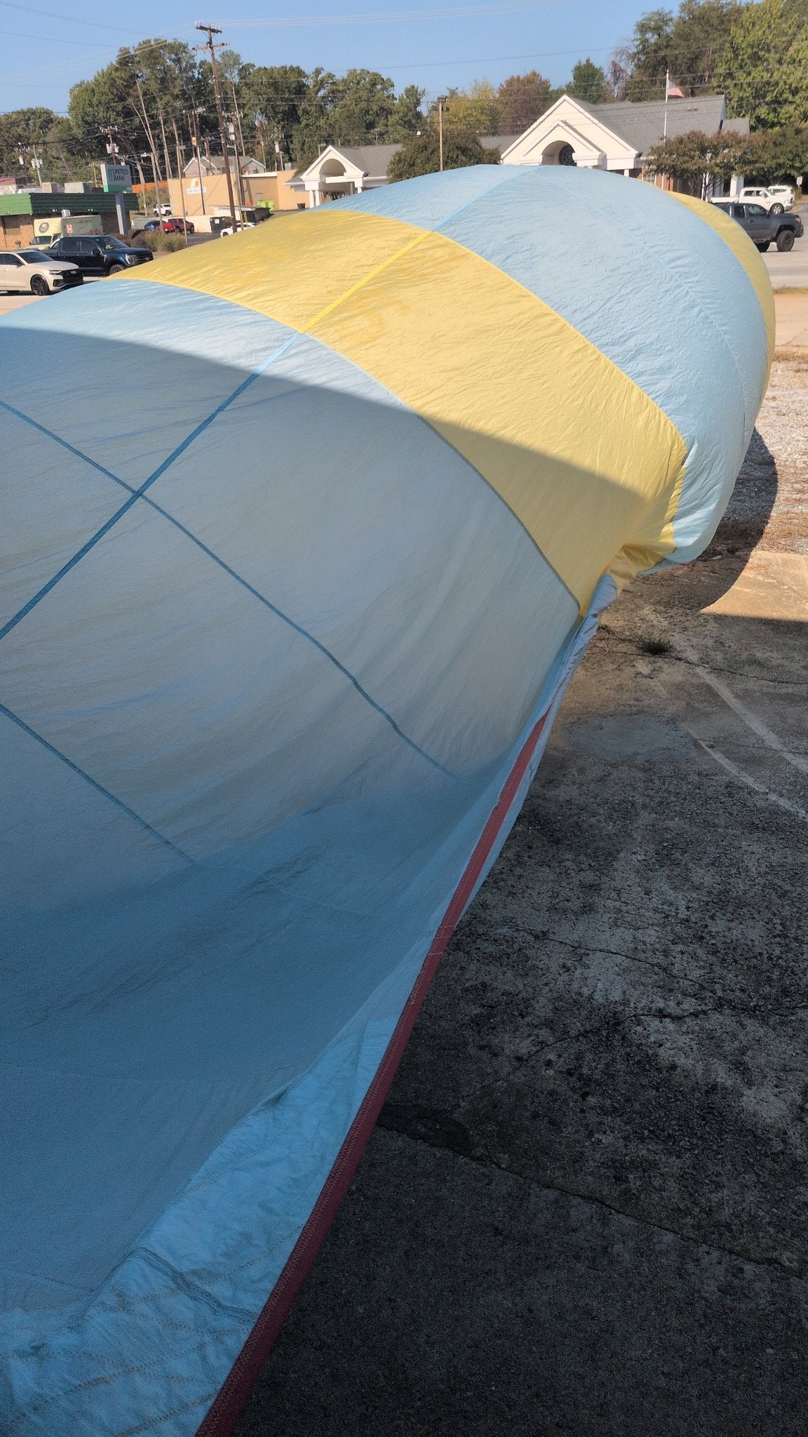 North Sails symmetric spinnaker catching wind — light blue and yellow