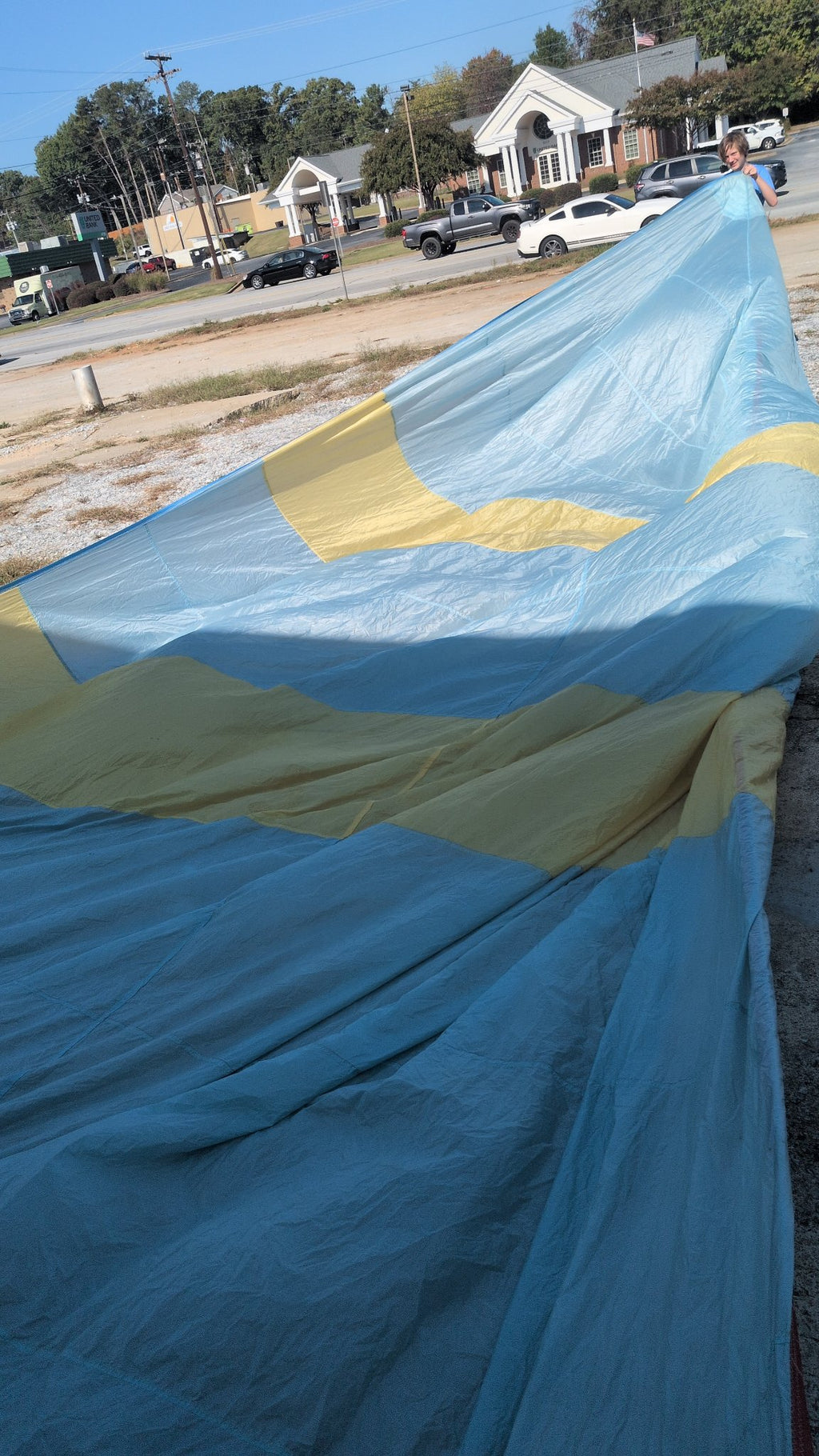 North Sails symmetric spinnaker laid out — light blue with yellow bands, 34 ft 9 in luff