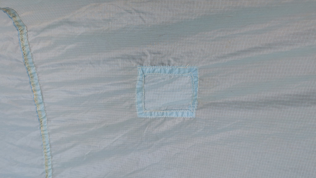 Detail — small sewn patch on the North Sails spinnaker cloth